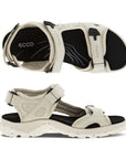 A pair of Ecco Yucatan white nubuck sandals with black accents on heel, instep and toe velcro straps, a black footbed, and a white outsole. 