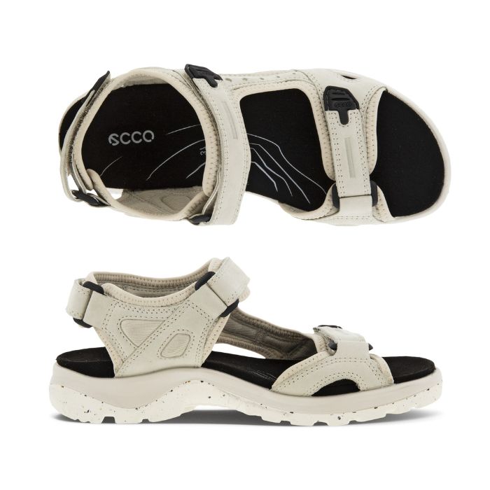 A pair of Ecco Yucatan white nubuck sandals with black accents on heel, instep and toe velcro straps, a black footbed, and a white outsole. 