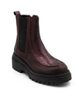 Warm purple Chelsea boot with suede and metallic leather upper, black elastic goring, and a black platform outsole. 